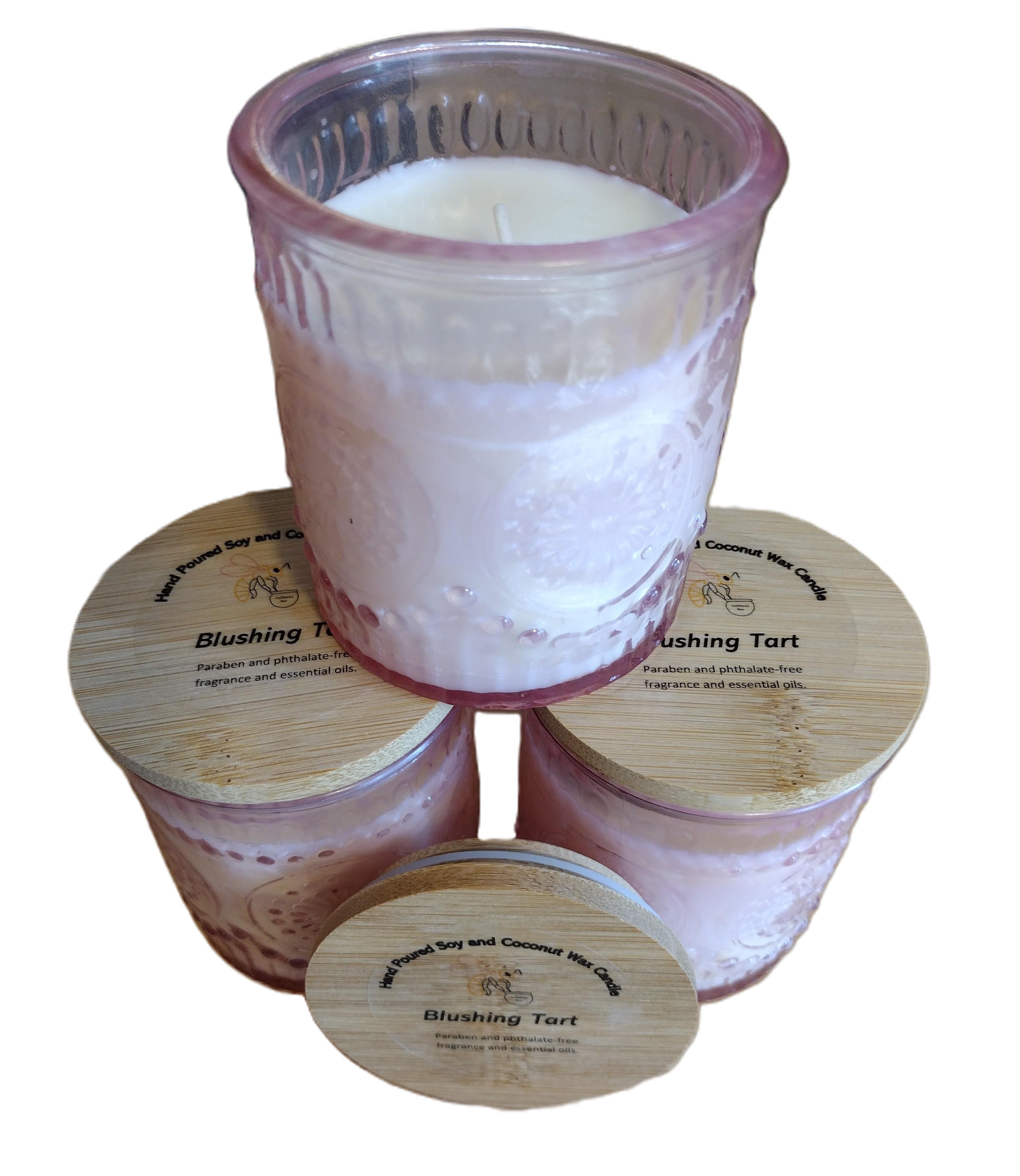 candle in pink glass jar with bamboo lid